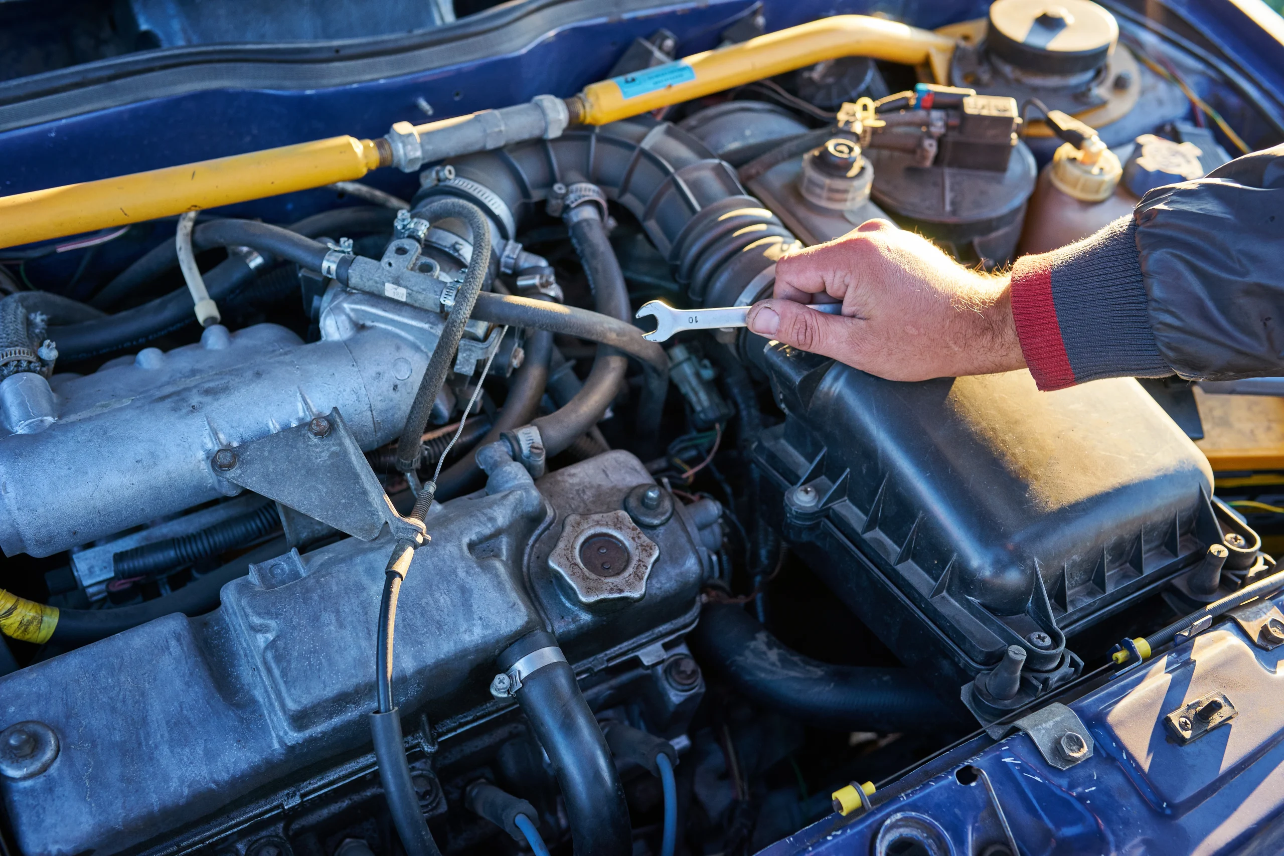 man tries repair broken car